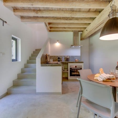 gite-kitchen-and-dining-area Casual Gite dining area with stairs to upper floors