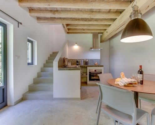 gite-kitchen-and-dining-area Casual Gite dining area with stairs to upper floors
