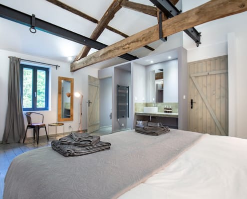Gite bedroom interior Interior of gite bedroom with exposed roof beams