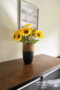 Sunflowers in vase on side table in dining room