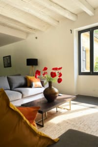 Sunlit corner of gite lounge with sofa