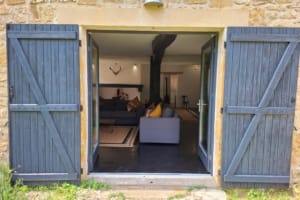 Gite entrance into the lounge with shuttered doors