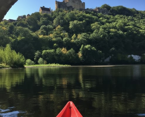 Canoeing past chateau under bridge Canoeing past chateau in Cadouin under bridge
