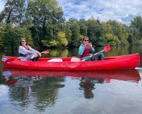 Having fun on the river Two friends having fun in a canoe on the River Dordogne