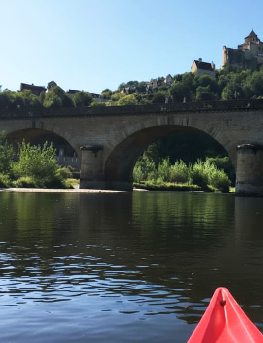 View of chateau on hill View of chateau on the hill and a bridge over the River Dordogne