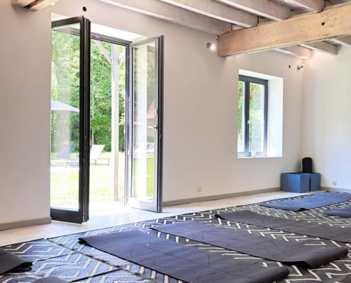 Wellness and yoga room Dordogne yoga room with exposed beam ceilings and yoga mats on the floor
