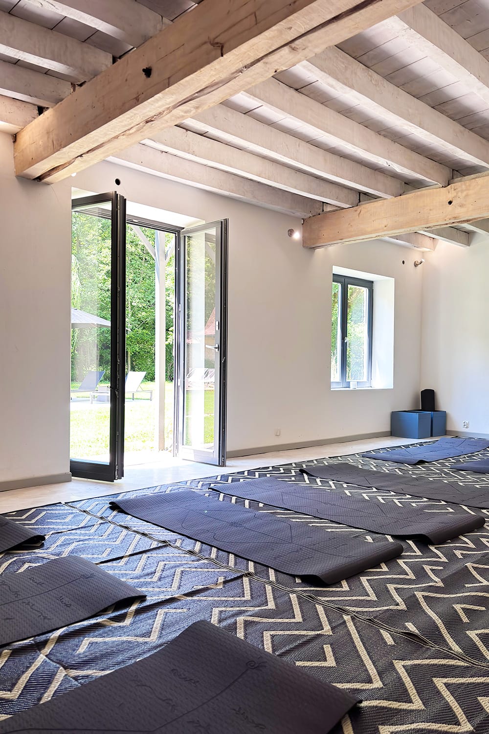 Wellness and yoga room Dordogne yoga room with exposed beam ceilings and yoga mats on the floor